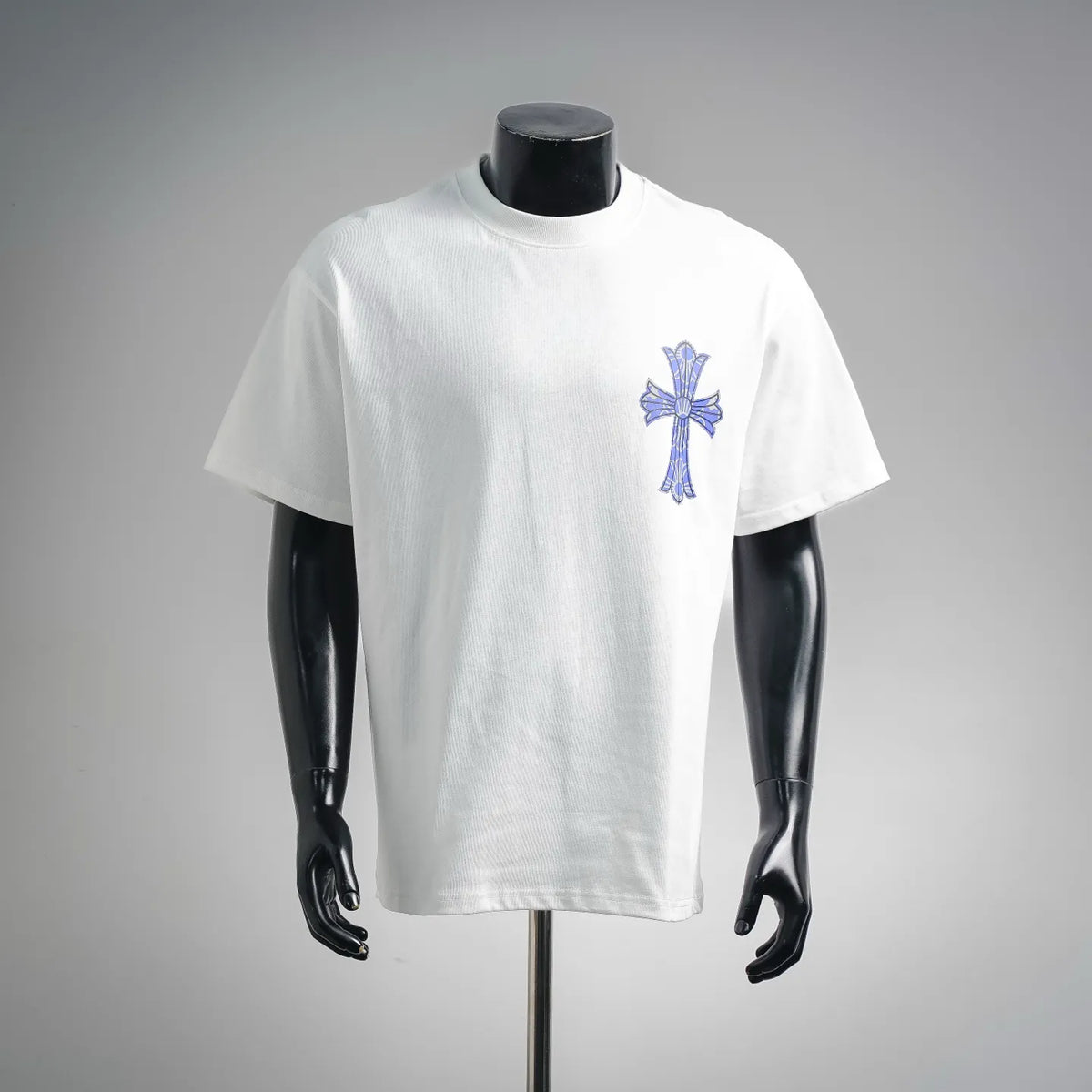White graphic T-shirt with blue cross design on the front
