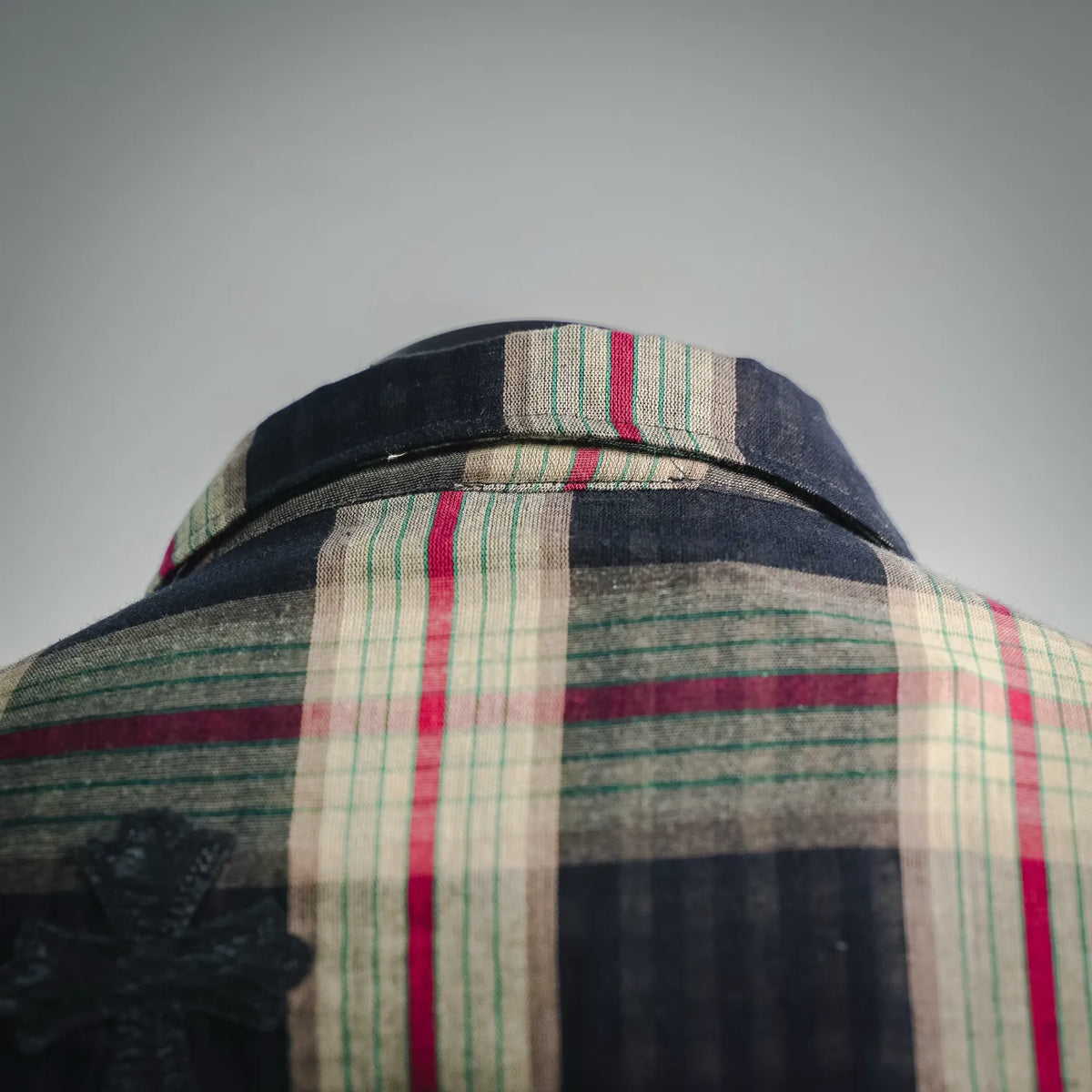 Plaid shirt collar and upper back with dark fabric and red and green stripe accents