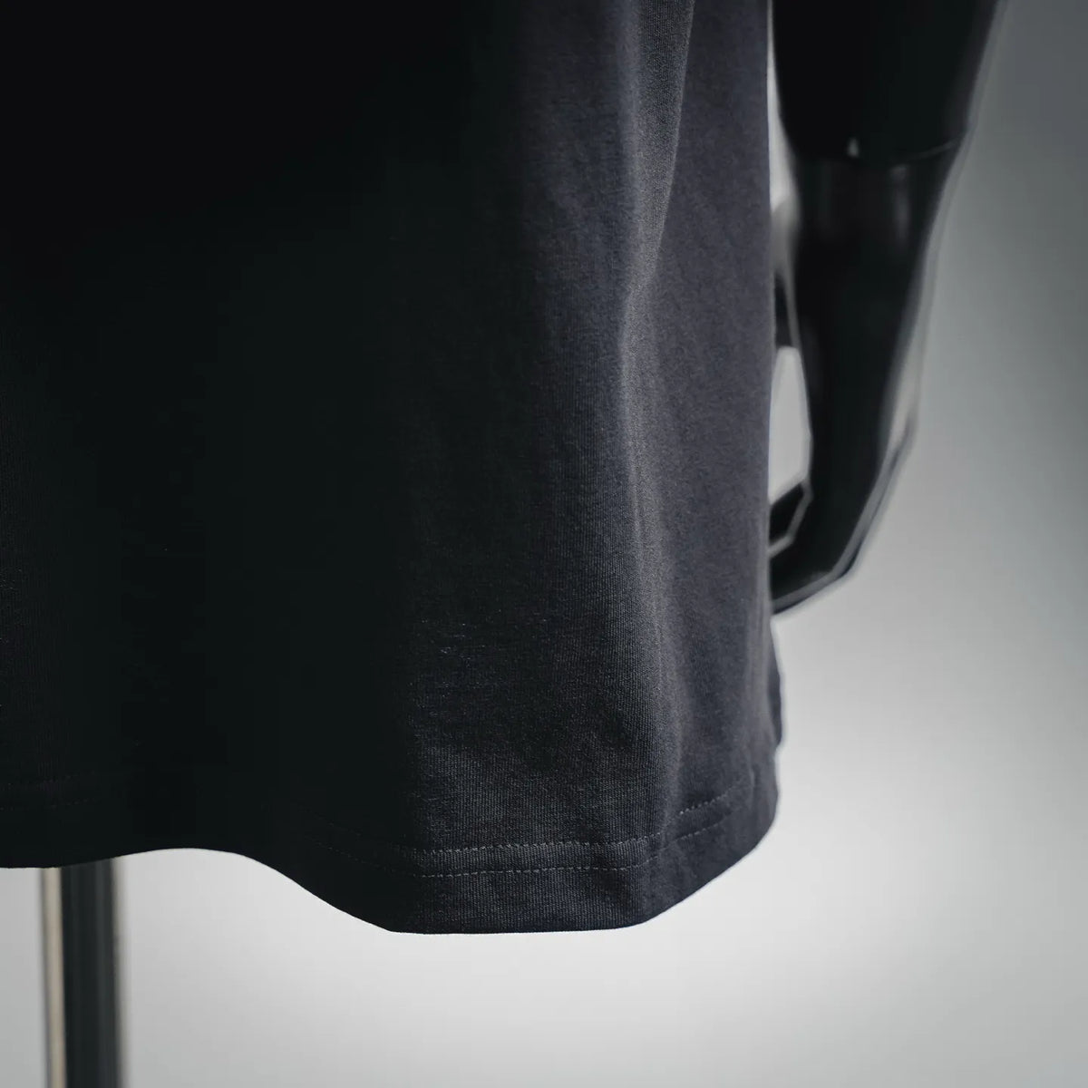 Black T-shirt hem with stitched bottom and sleeve edge