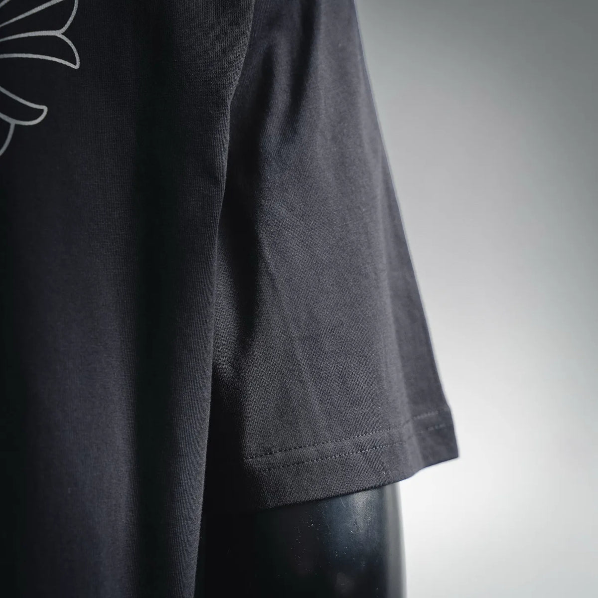 Black T-shirt side hem with stitched seam detail