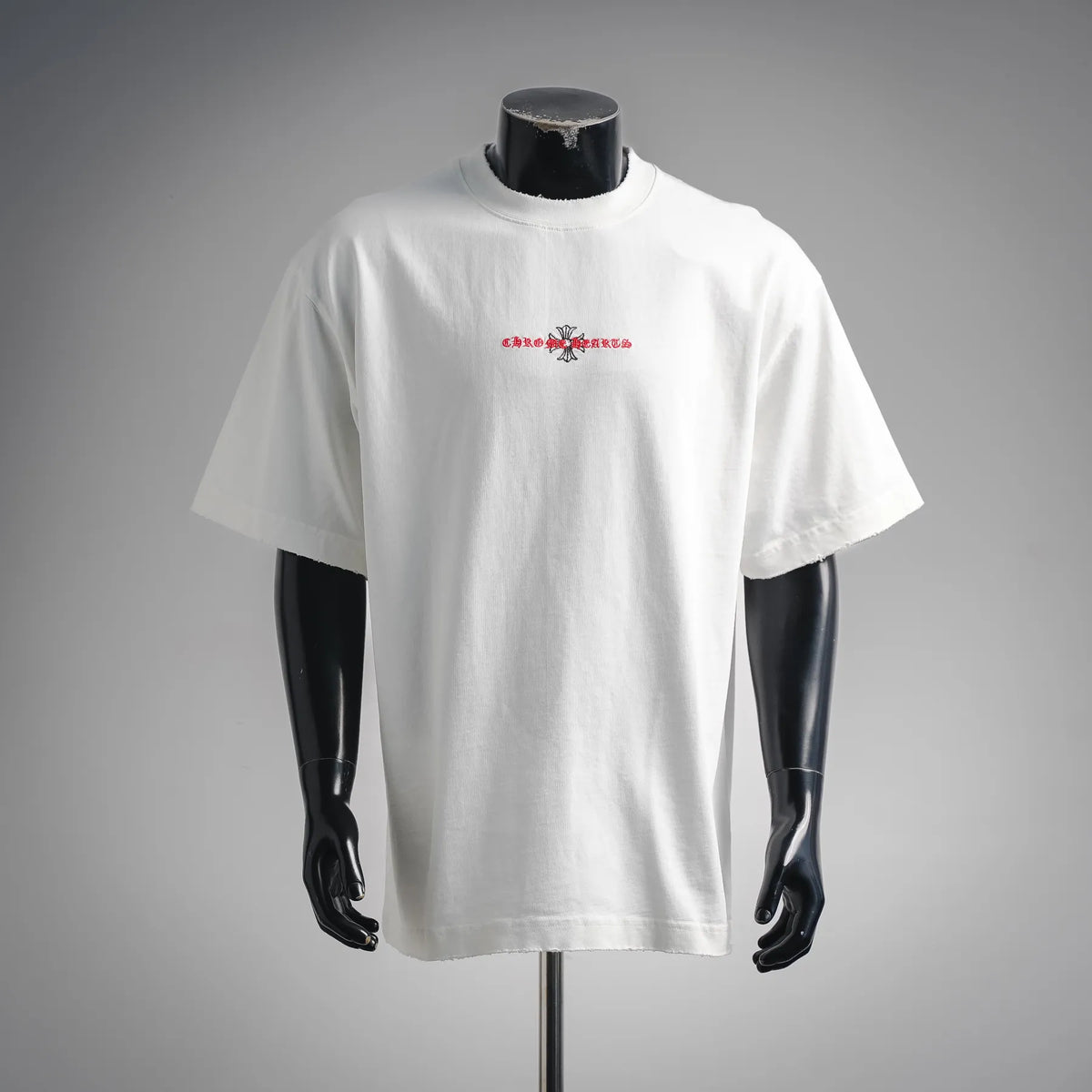 White short-sleeve T-shirt with small red and black chest graphic