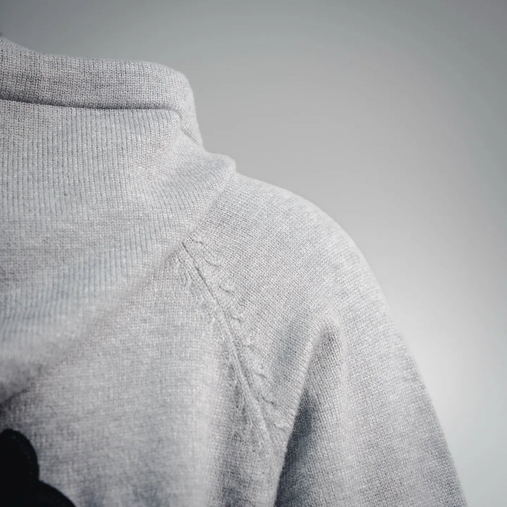 Light gray hoodie hood with drawstring cord and stitched seam detail.