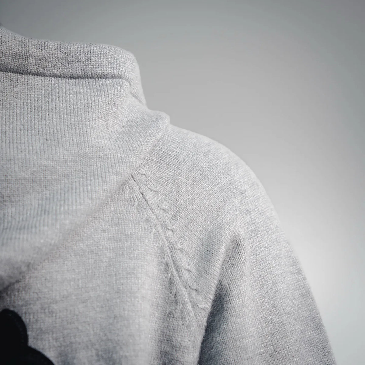 Light gray hoodie hood with drawstring cord and stitched seam detail.