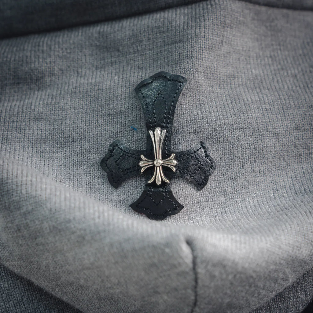 Light gray hoodie with dark cross graphic applique and small jeweled accents.