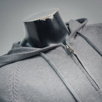 Light gray zip-up hoodie with front zipper and hood collar detail.