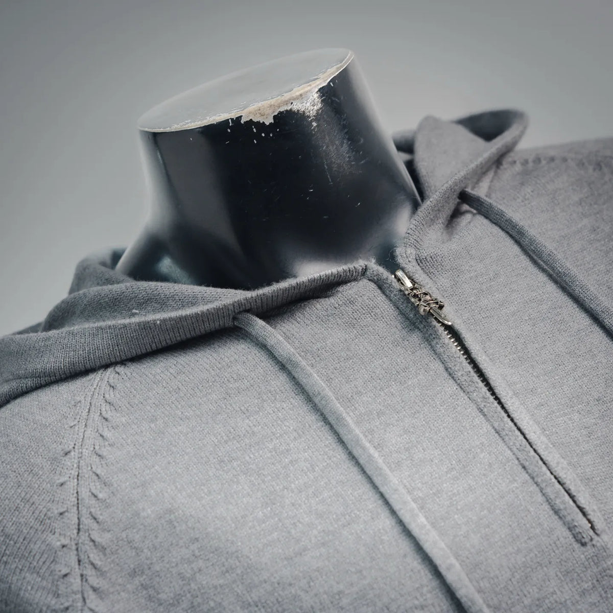 Light gray zip-up hoodie with front zipper and hood collar detail.