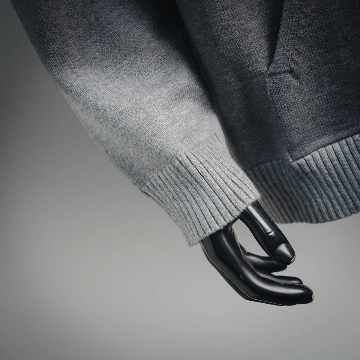 Light gray hoodie sleeves with ribbed cuffs.