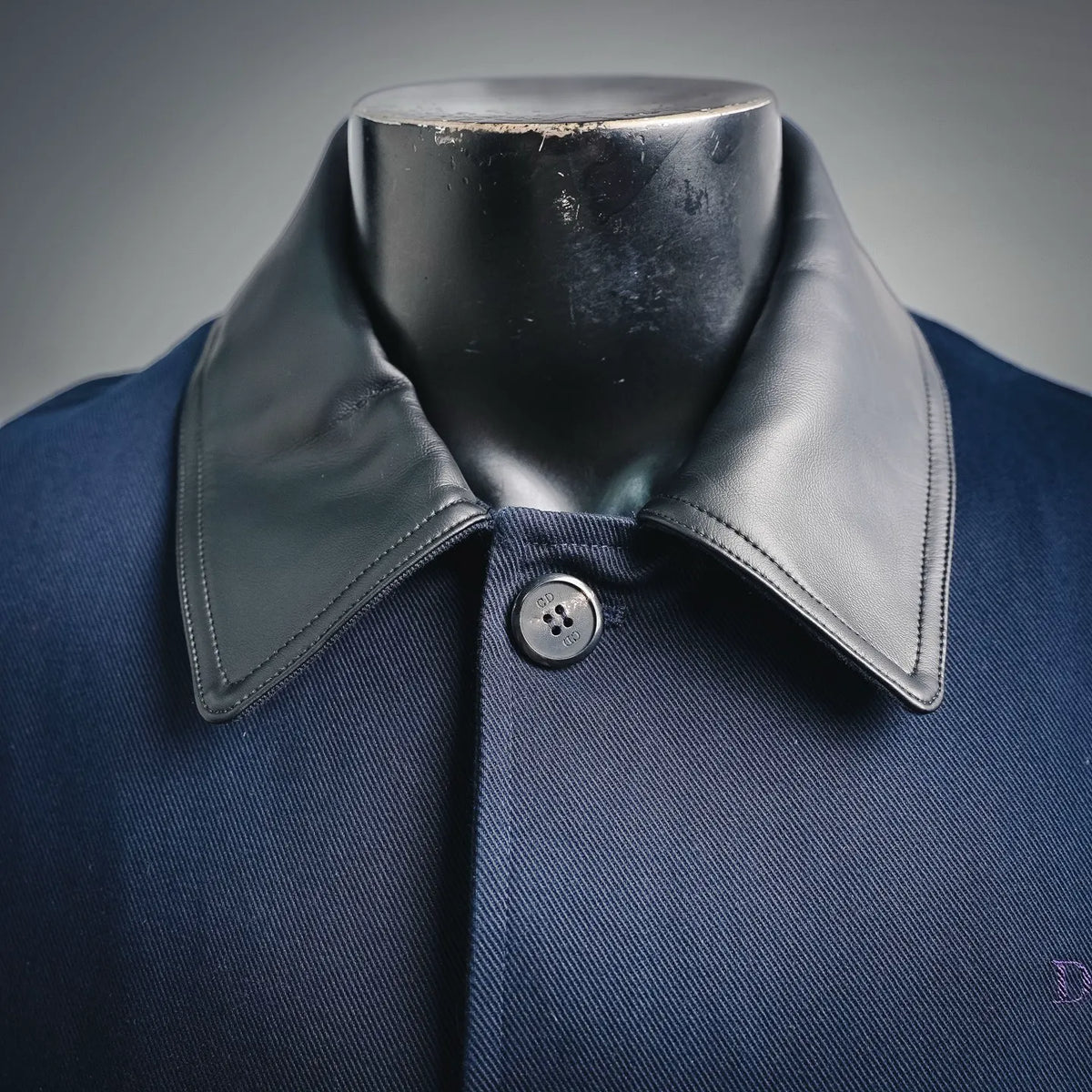Navy denim coat with black leather-look pointed collar and buttoned front placket