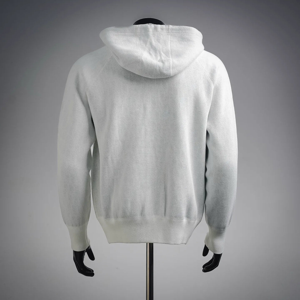 White zip-up hoodie coat with attached hood and ribbed hem, back view