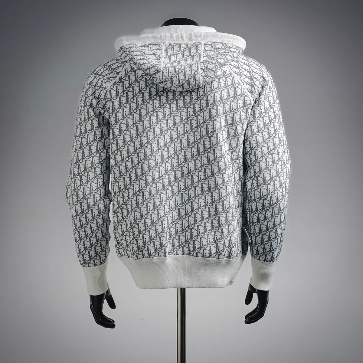 White zip-up hoodie coat with allover pattern, back view and ribbed cuffs