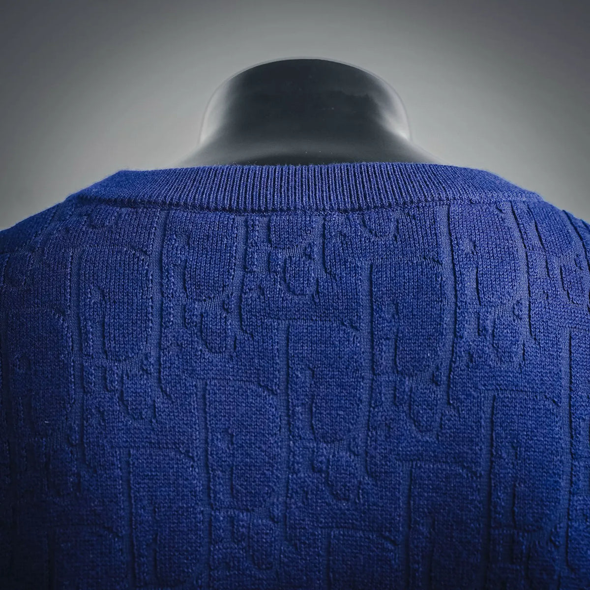 Close-up of blue textured knit sweater back yoke