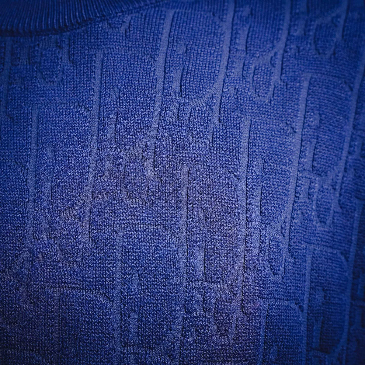 Close-up of blue textured knit sweater fabric pattern