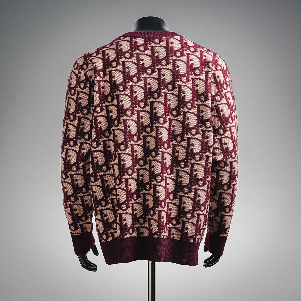 Long-sleeve knit sweater with burgundy and beige monogram pattern, ribbed hem and cuffs