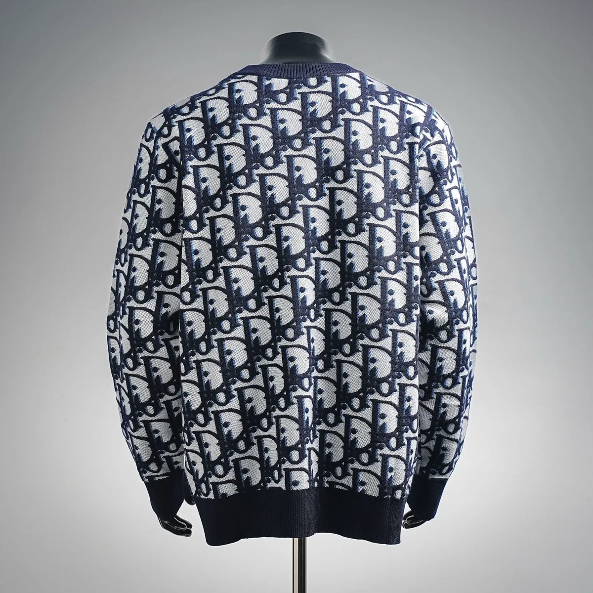 Dior knit sweater, back view with blue-and-white logo pattern, ribbed hem