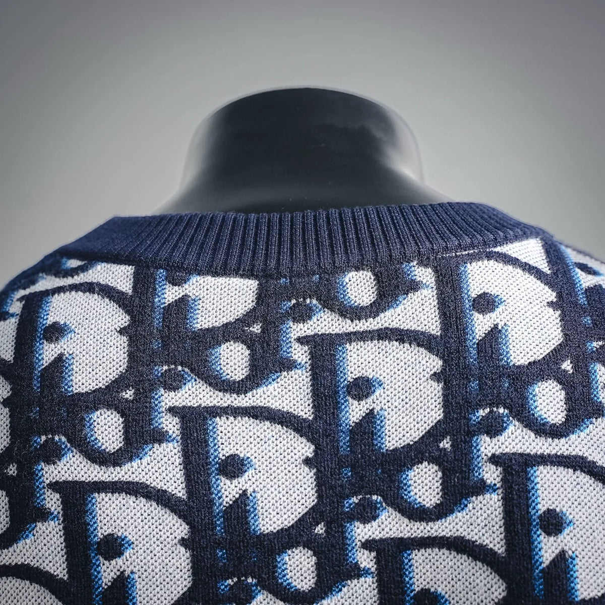 Dior knit sweater, ribbed collar and allover blue-and-white pattern, shoulder detail