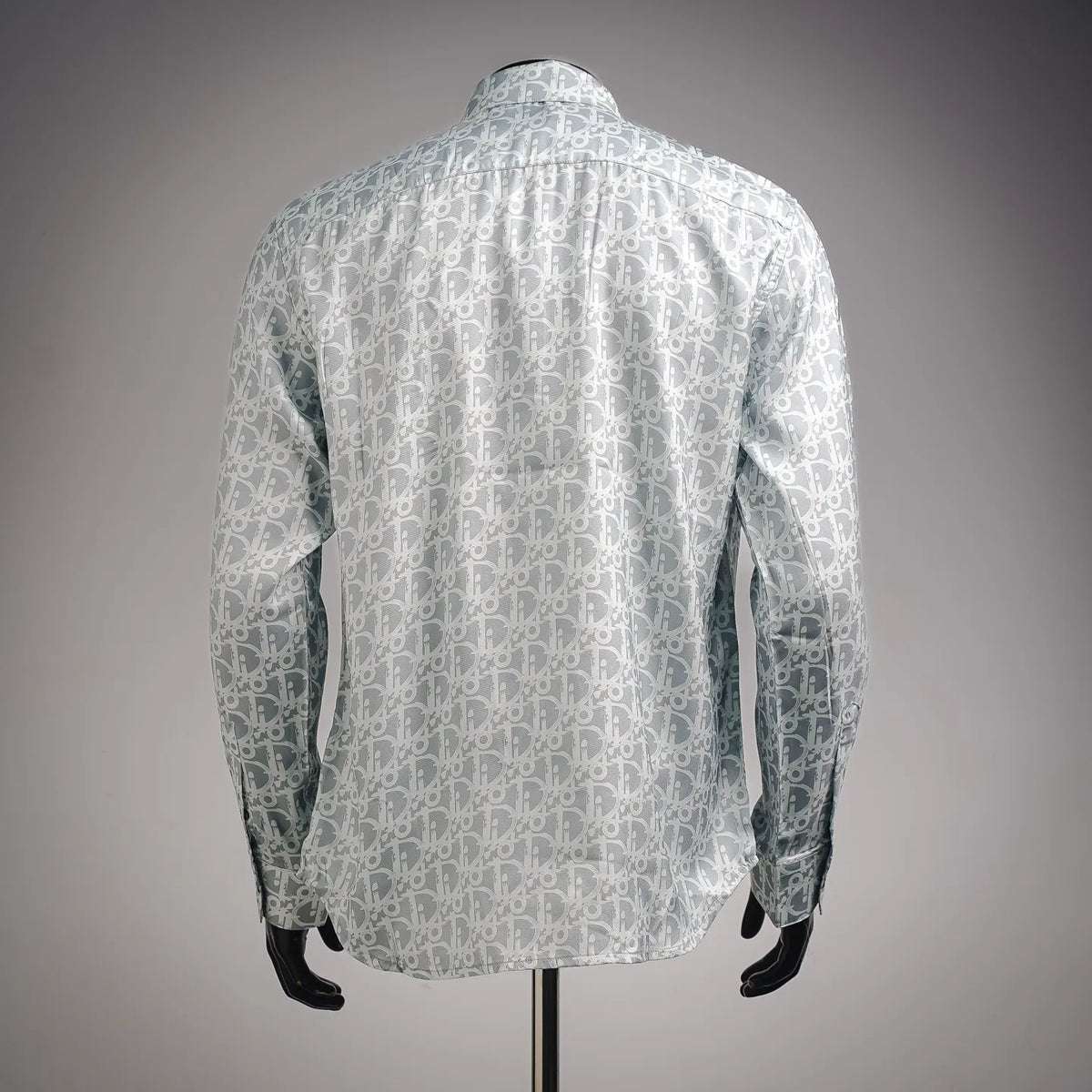 Back view of long-sleeve button-up shirt with light blue and white monogram pattern