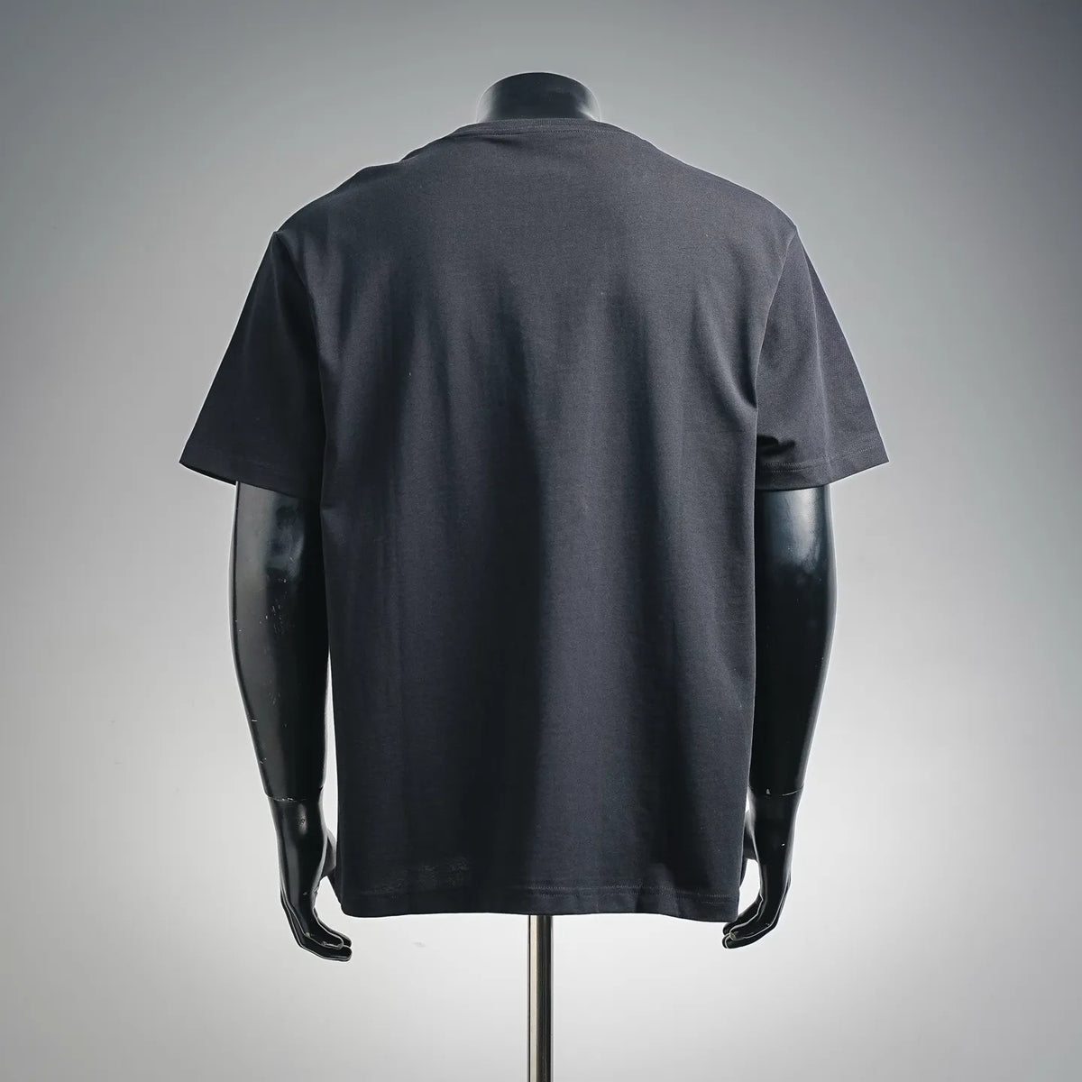 Black crewneck T-shirt, back view on a mannequin