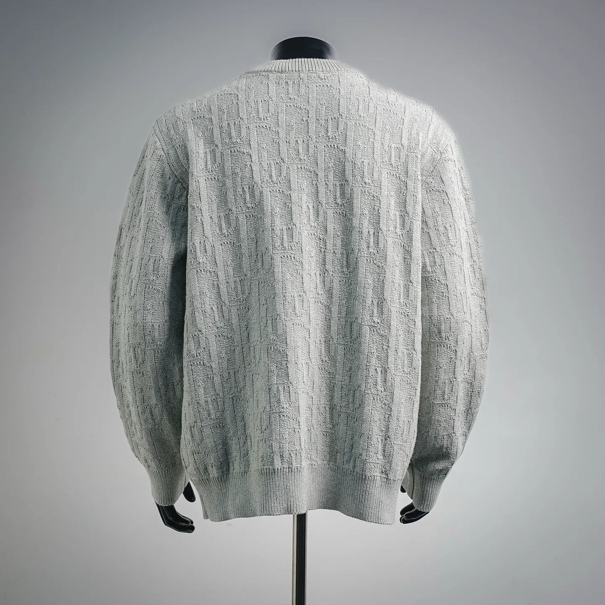 Light gray cable-knit sweater, back view with crew neck and long sleeves