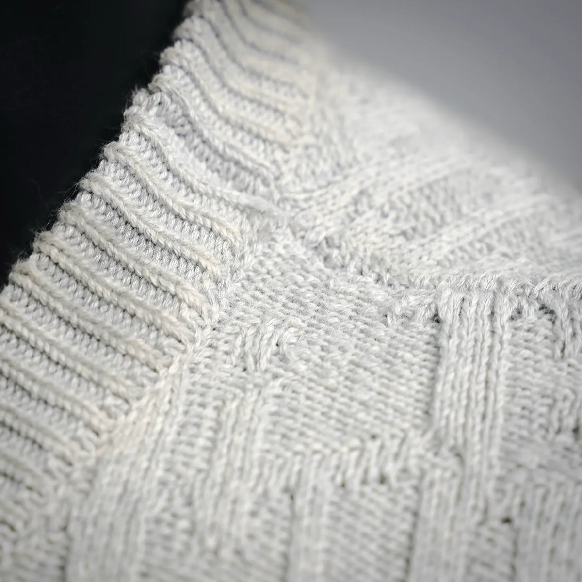 Light gray knit collar and cable stitch pattern on sweater