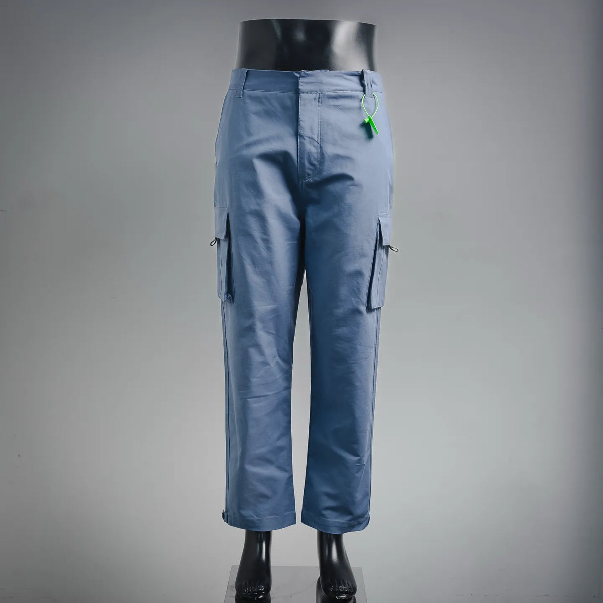 Light blue cargo pants with side flap pockets and adjustable drawcord at waist.