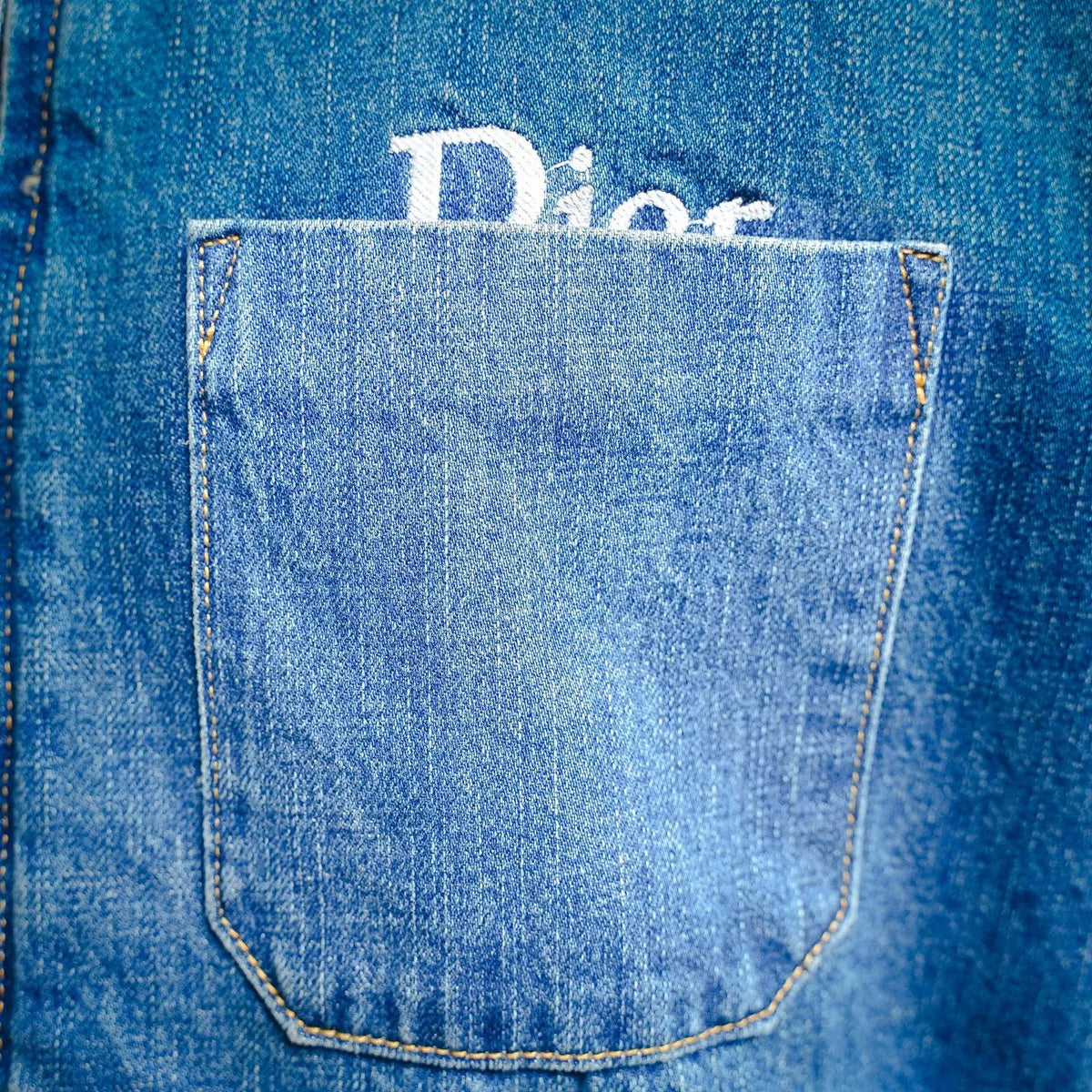 Front chest pocket on light blue Dior denim jacket
