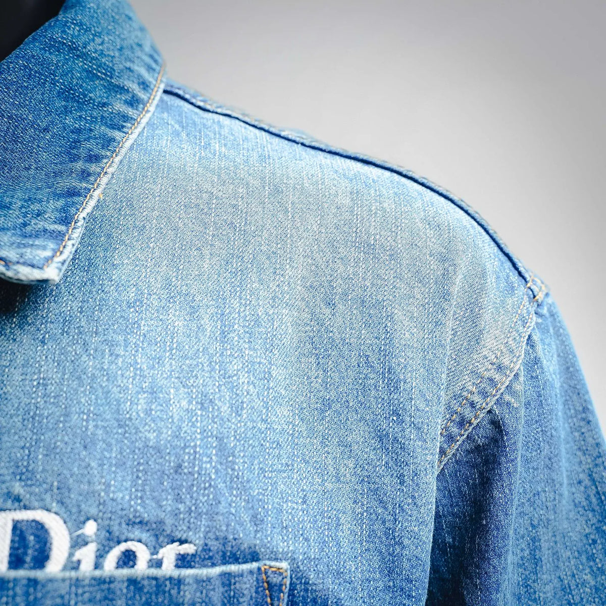 Light blue Dior denim shoulder detail with stitched seam
