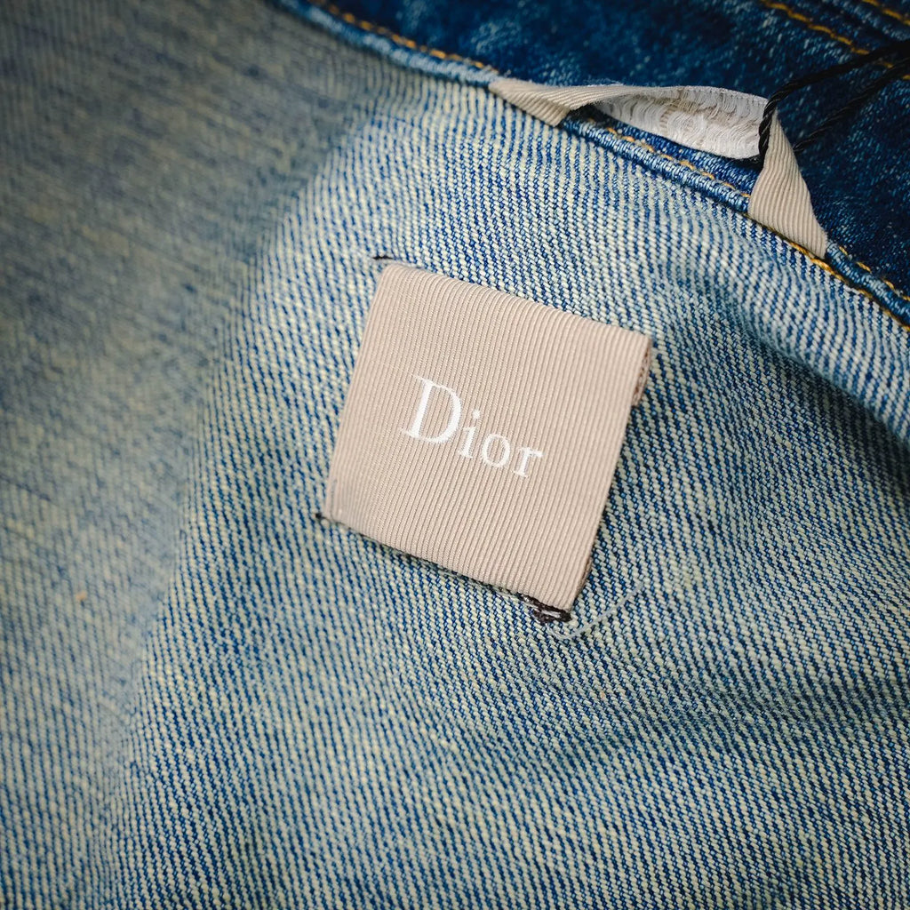 Beige Dior logo patch label on light blue denim interior