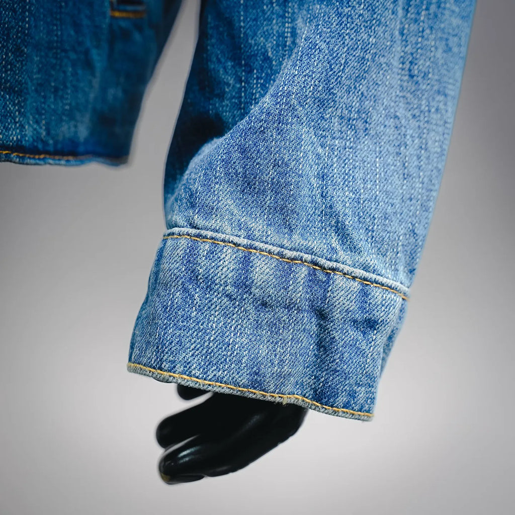 Light blue denim jacket sleeve cuff with stitched hem