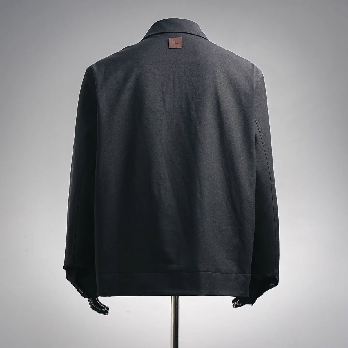 Black back view of zip-up coat with stand collar