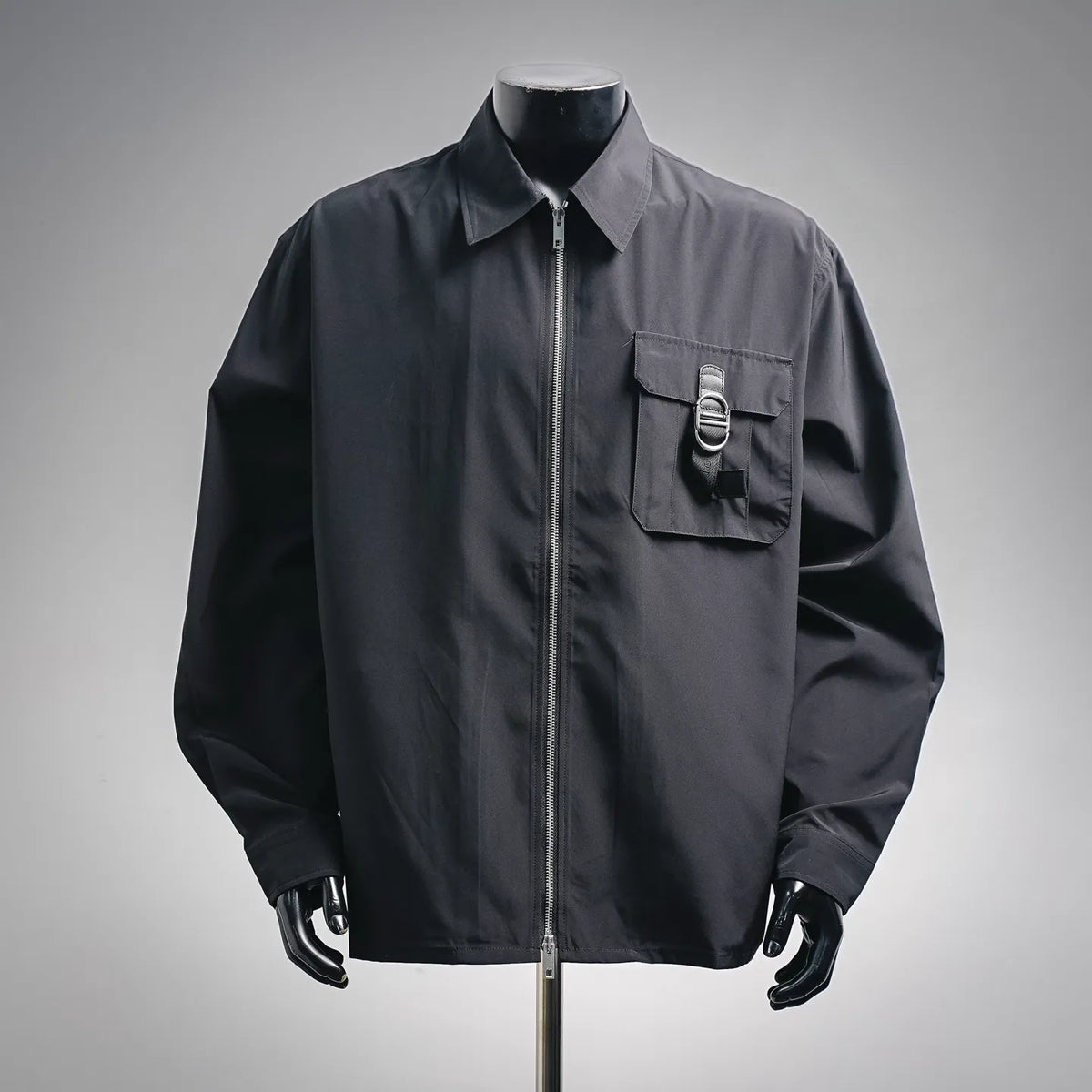 Dior dark zip-up coat with pointed collar, chest flap pocket, and front zipper