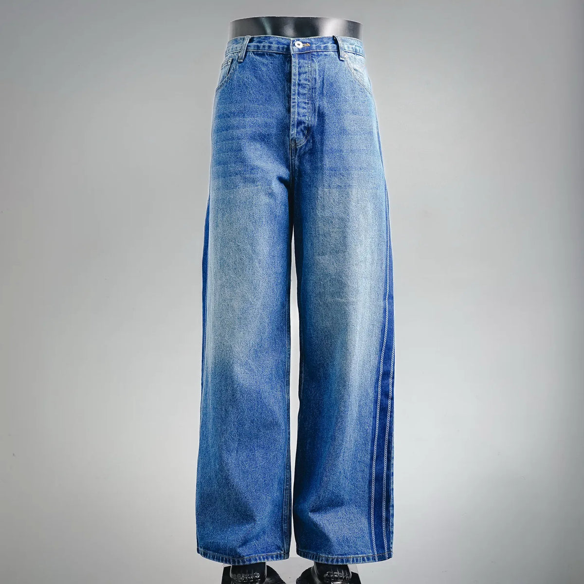 Light blue wide-leg denim pants with front button closure and belt loops