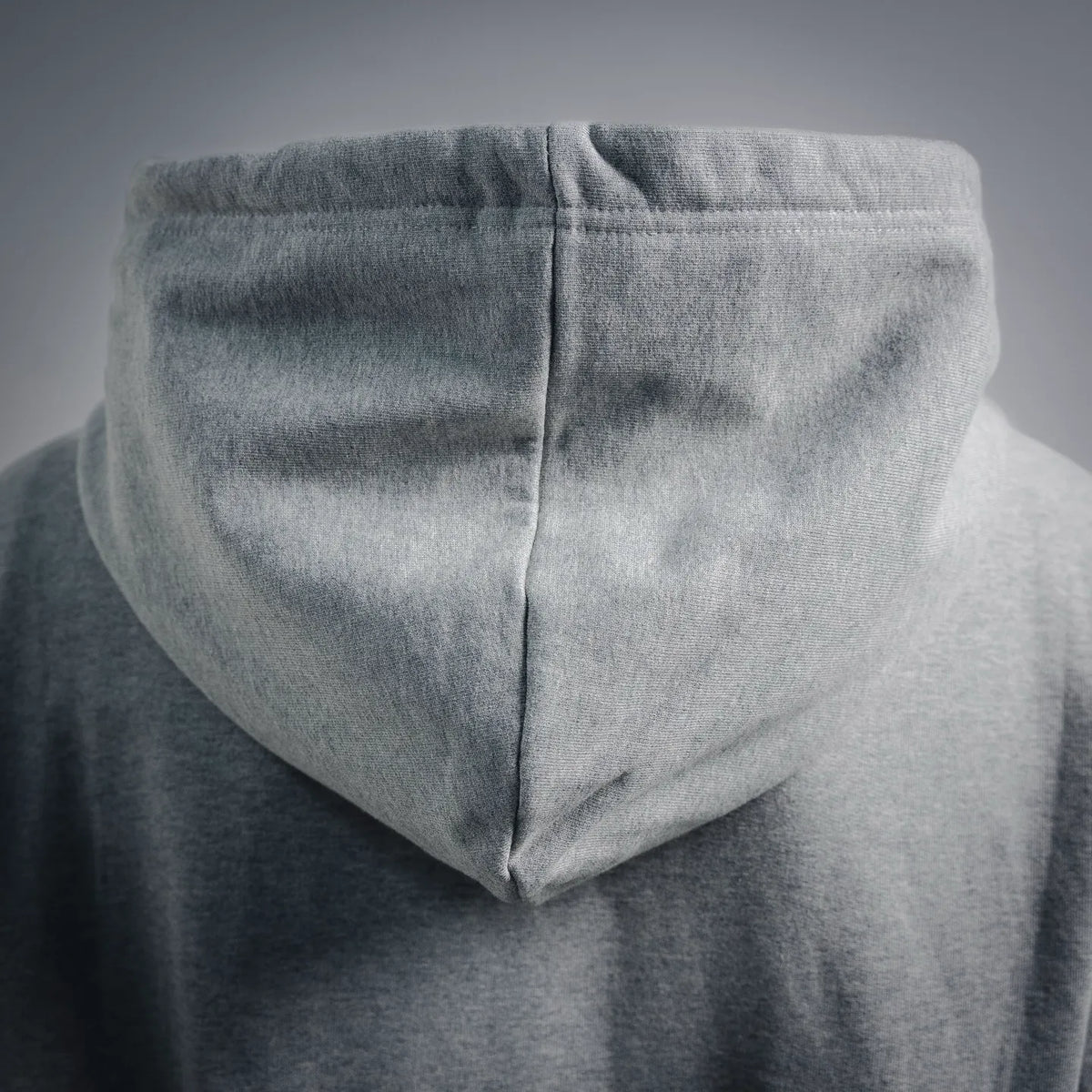 Gray hoodie with hood, center seam, and kangaroo pocket from close rear angle