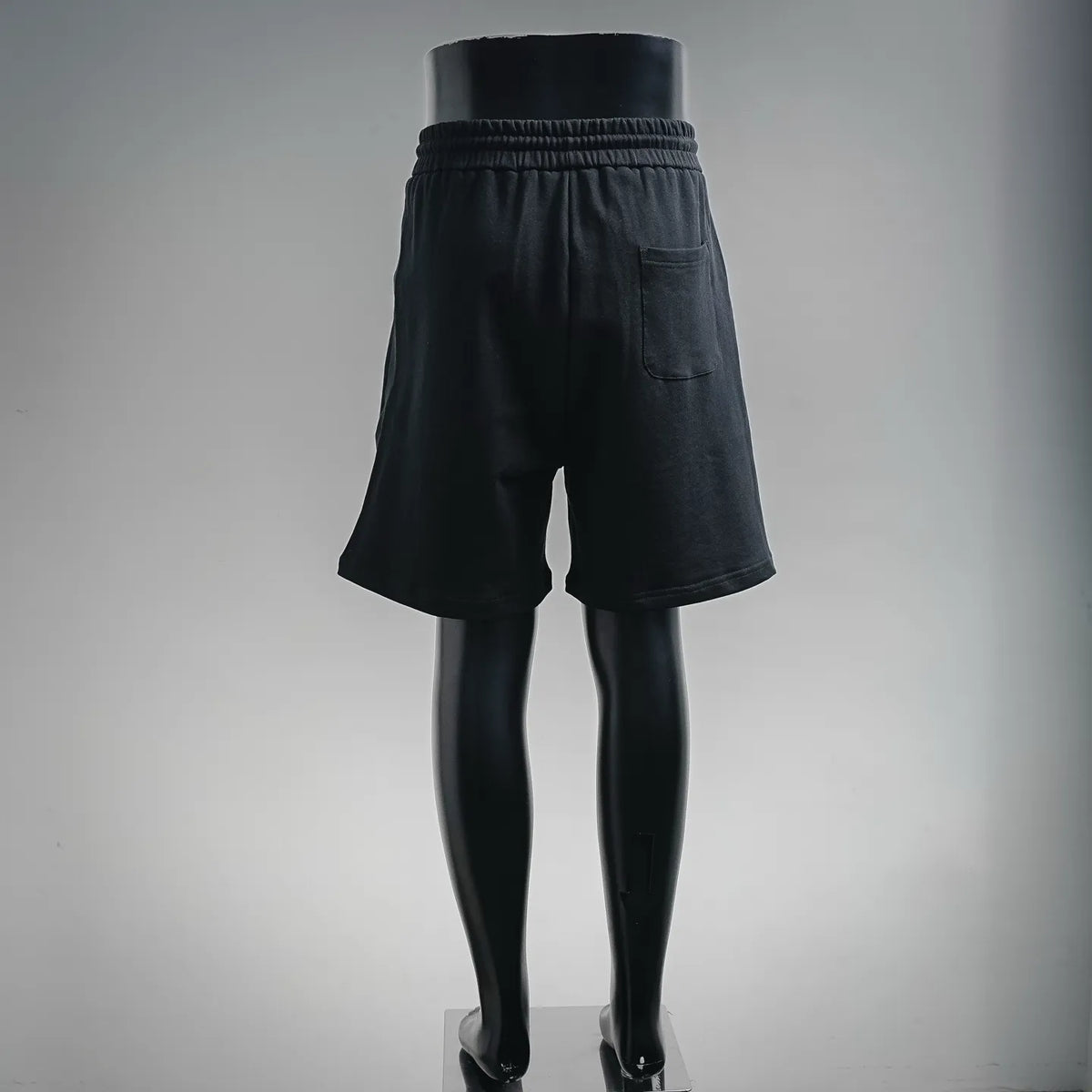 Dior black drawstring shorts, back view with patch pocket and elastic waist