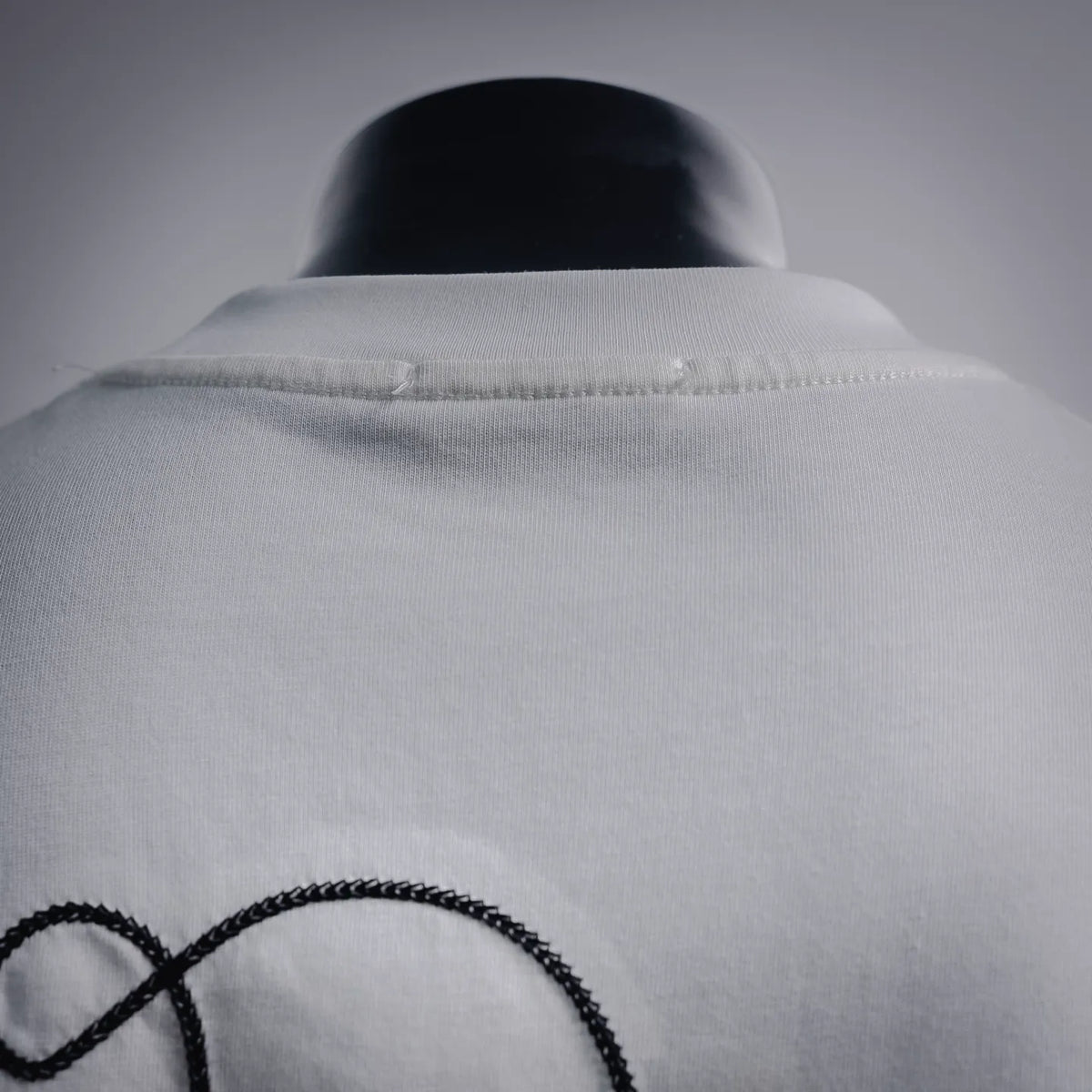 White crewneck T-shirt collar with stitched neckline detail.