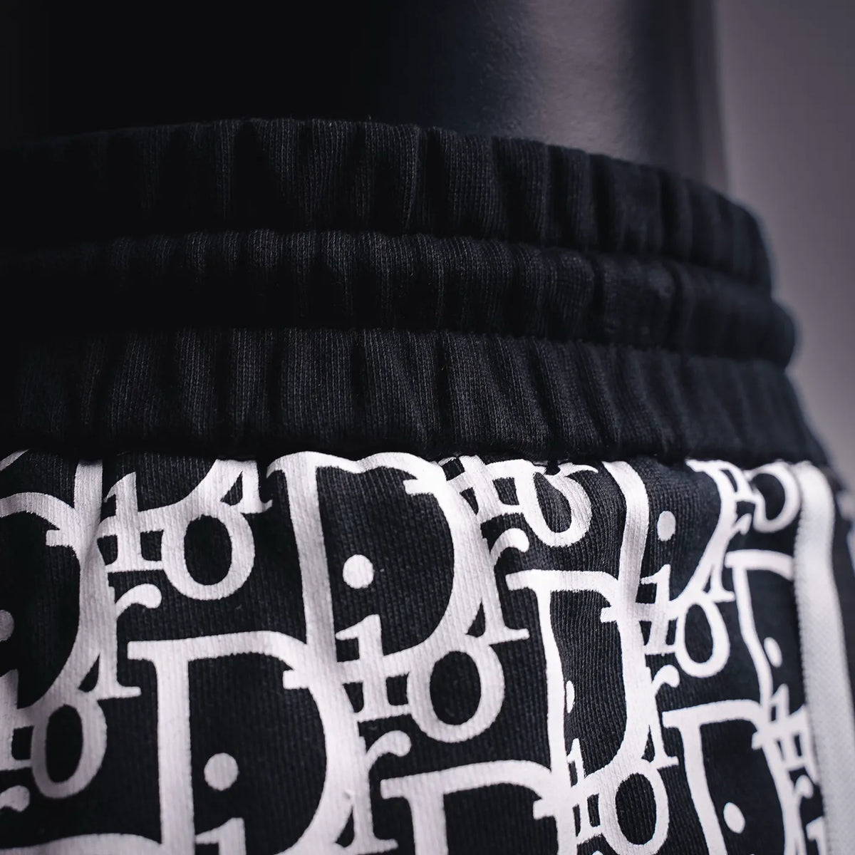Waistband and drawstring area on black-and-white Dior logo shorts