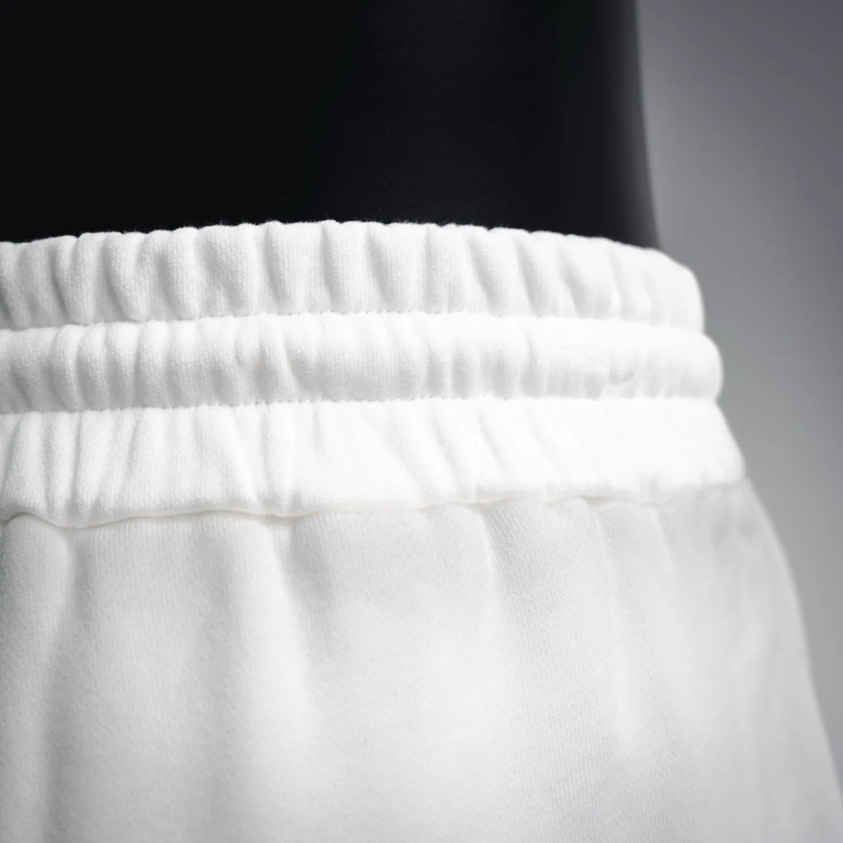 White shorts waistband with layered elastic seam detail