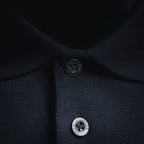 Dior polo collar close-up with dark buttons on button placket