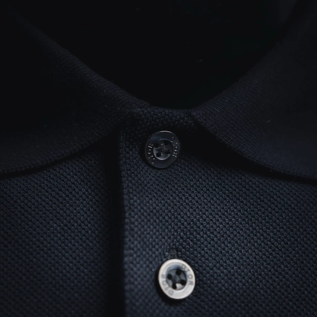 Dior polo collar close-up with dark buttons on button placket
