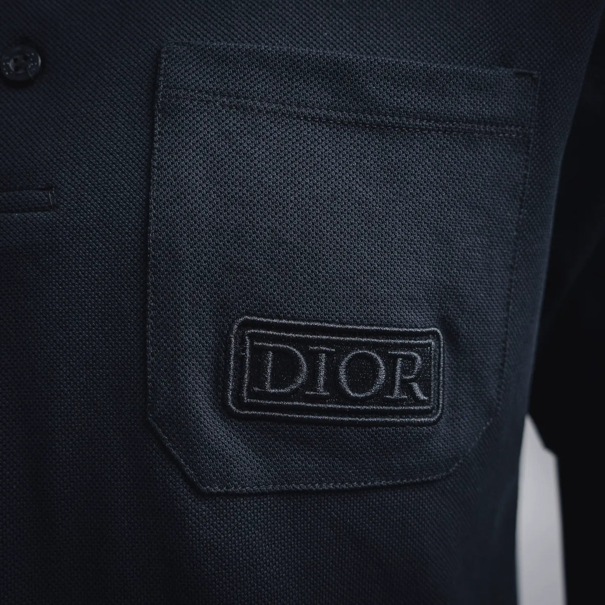 Dior polo chest pocket logo patch on dark navy knit fabric