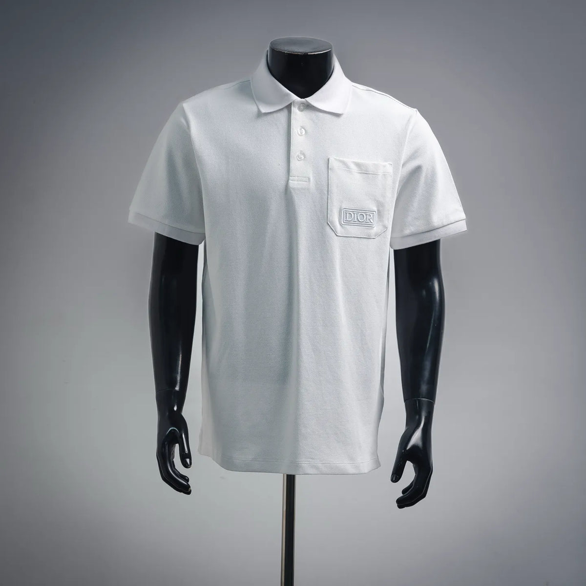 White polo shirt with pointed collar, three-button placket, and Dior chest pocket logo