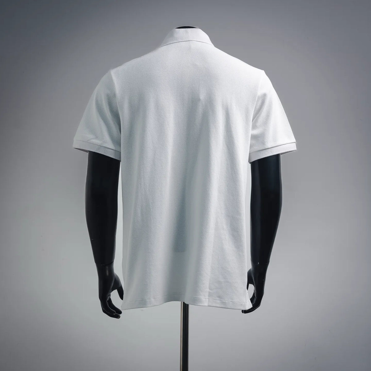 White polo shirt back view with short sleeves and smooth fabric surface