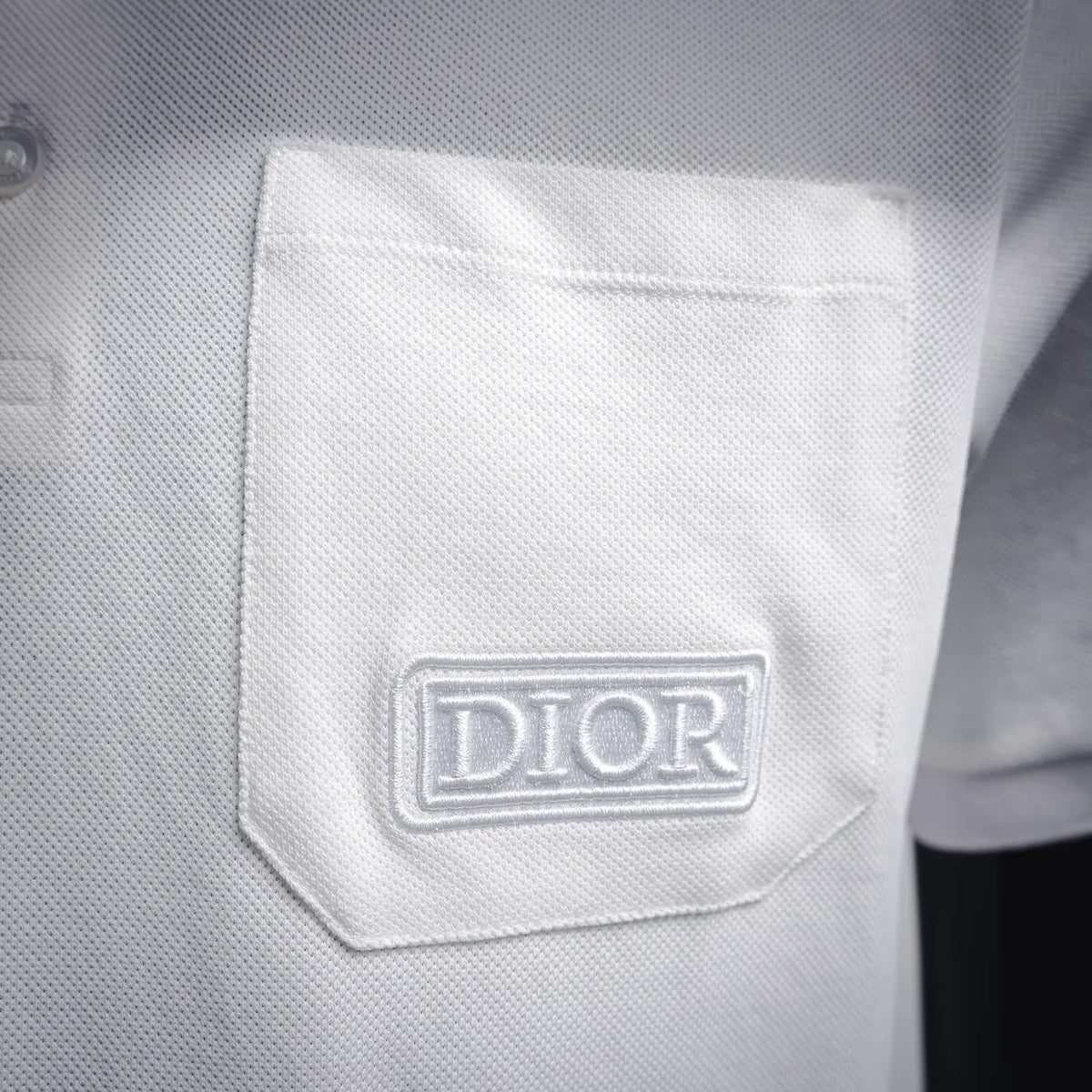 White polo shirt chest pocket with Dior logo patch