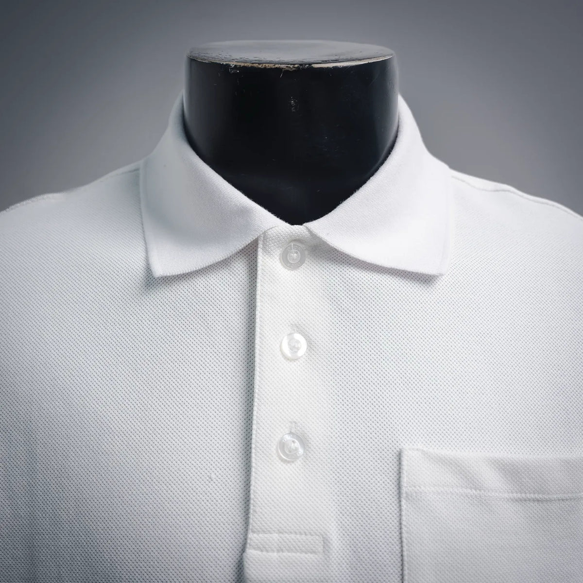 White polo shirt neckline with three buttons and pointed collar