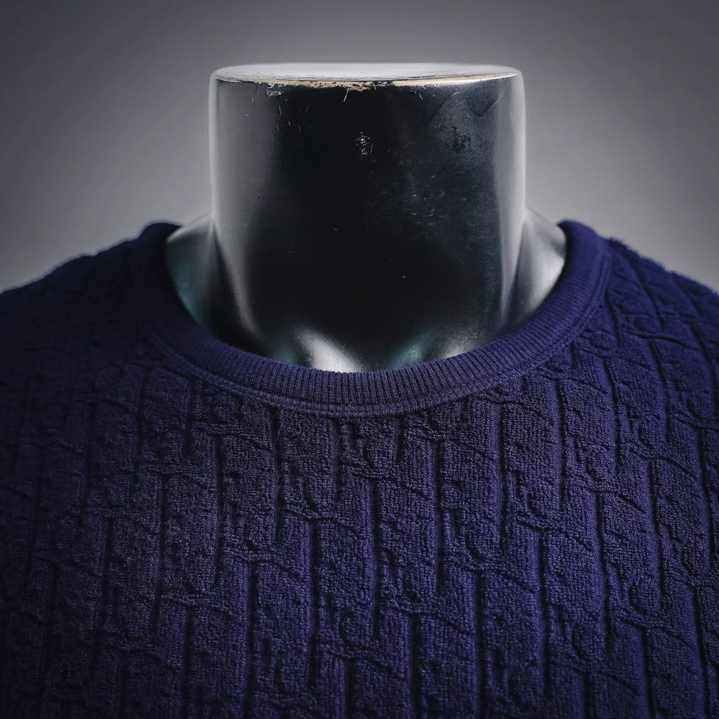 Dark blue textured knit shirt with crew neck ribbed collar close-up