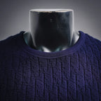 Dark blue textured knit shirt with crew neck ribbed collar close-up
