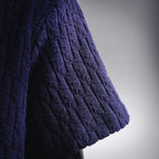 Dark blue short-sleeve knit shirt side view with ribbed hem and textured fabric