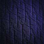 Dark blue textured knit fabric close-up with raised pattern