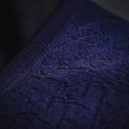 Dark blue knit fabric close-up with visible texture and stitching