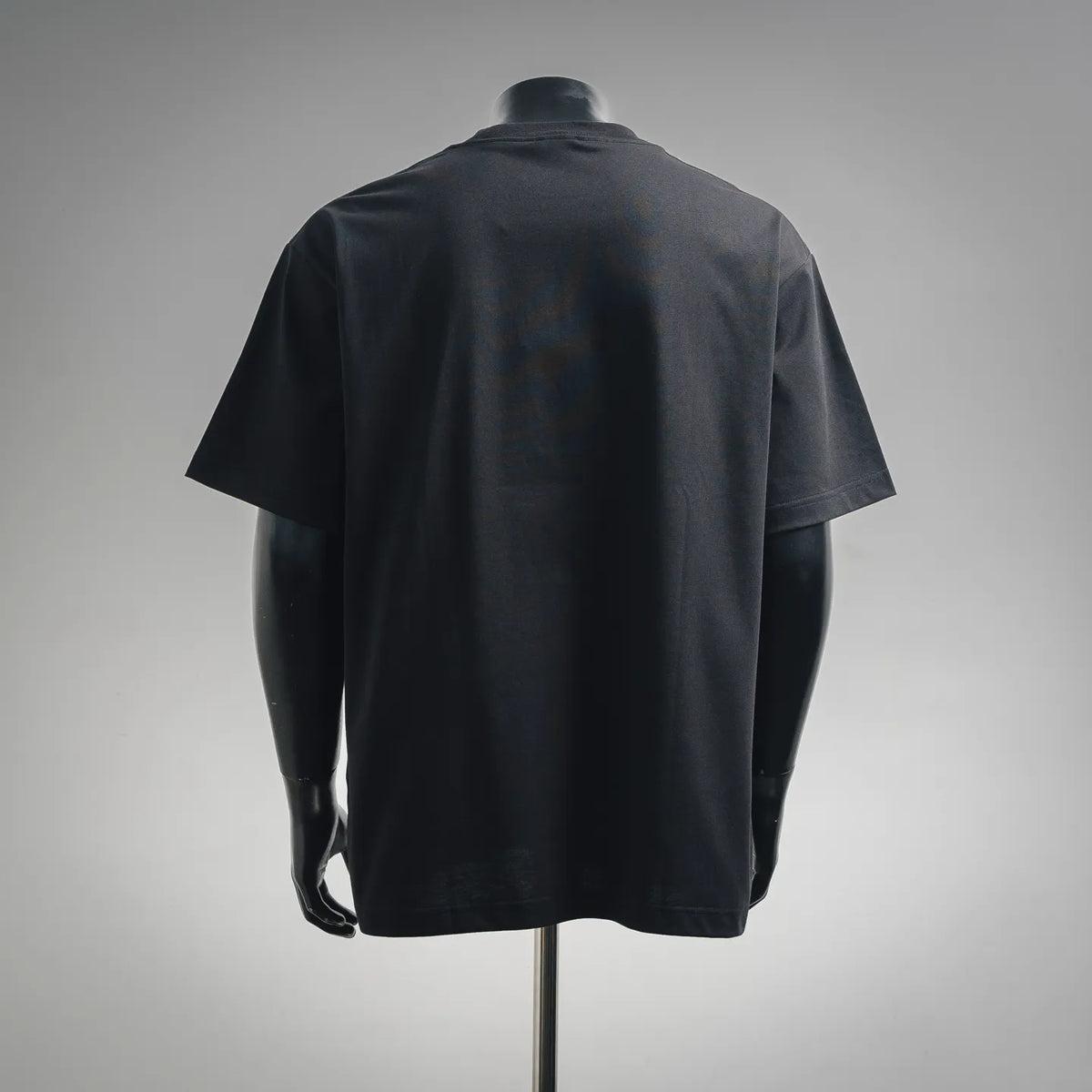 Dior dark short-sleeve T-shirt shown from the back on a mannequin