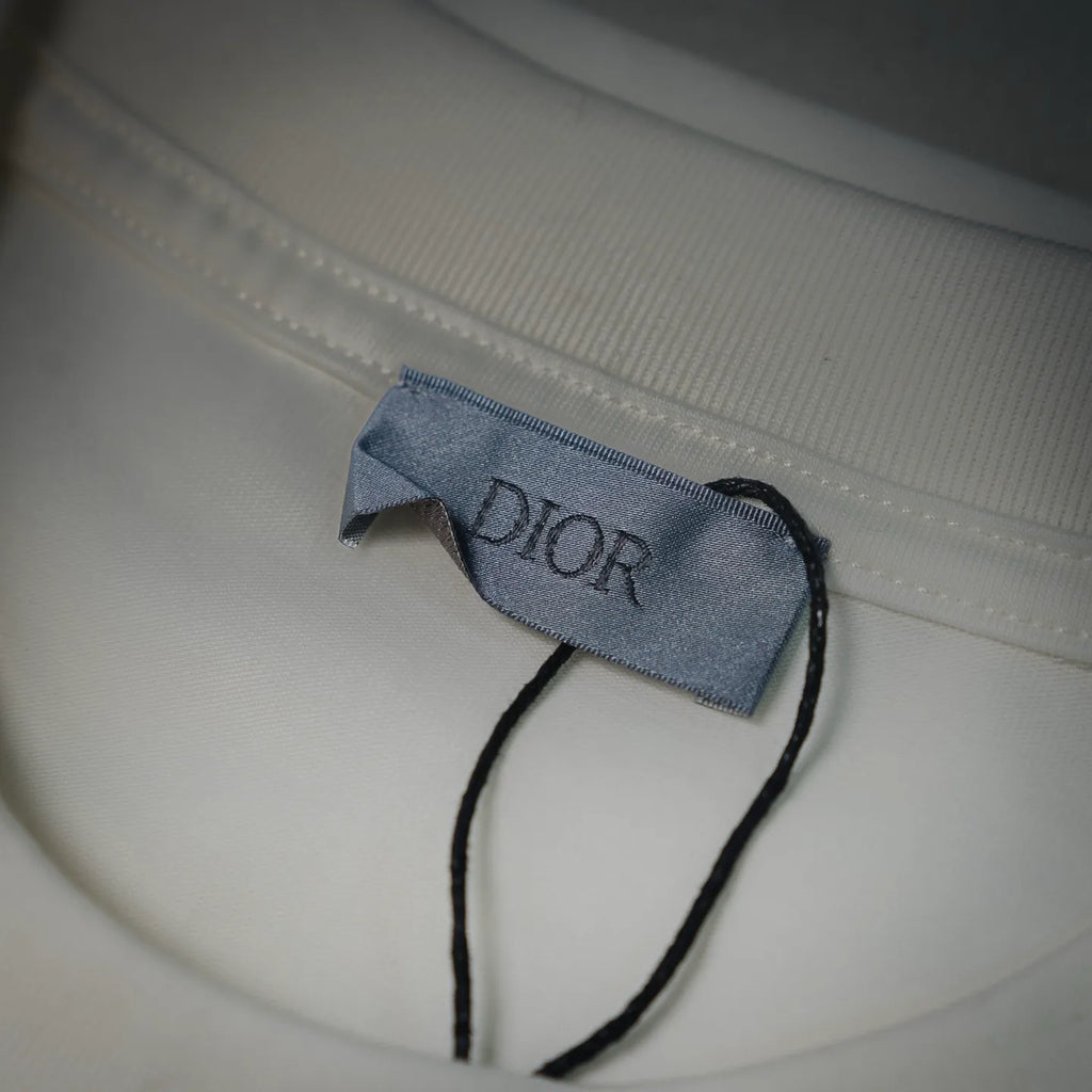 Inside neck label and stitching on white Dior crewneck T-shirt